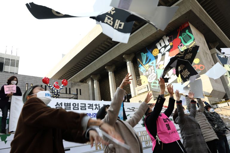 South Korean activists throw placards on discrimination against women during a protest to mark International Women's Day on March 08, 2021 in Seoul, South Korea. The protesters called for an equal society that is free from institutional discrimination, so that women can enjoy equal rights with men and live with dignity and pride, and to build a democratic society where everyone's political, economic, social, and cultural rights are fully guaranteed. (Photo by Chung Sung-Jun/Getty Images)