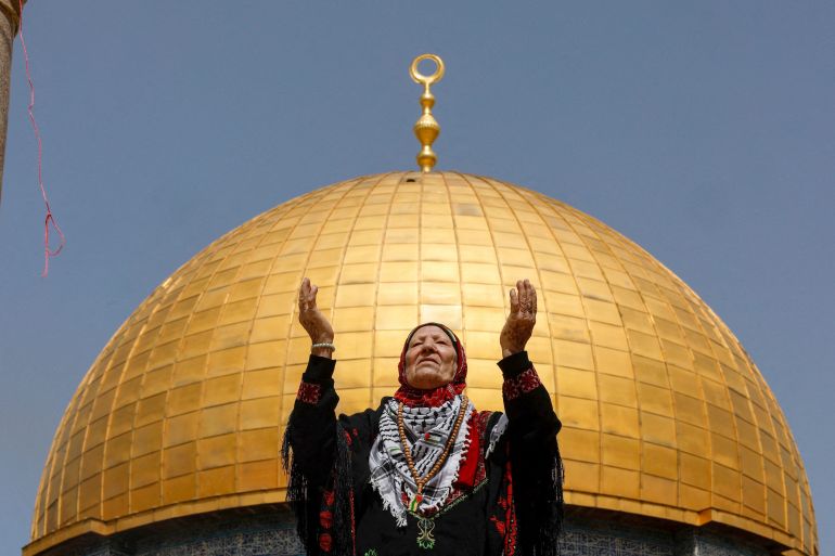 A woman prays as Palestinian Muslims attend Friday prayers of the Muslim holy month of Ramadan, on the Al-Aqsa mosque compound in Jerusalem's Old City.