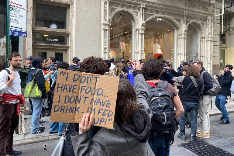 A protestor holds a sign showing some of Neely's last attributed words