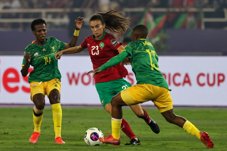 South Africa's defender Bambanani Mbane (R) and South Africa's midfielder Nomvula Kgoale (L) mark Morocco's forward Rosella Ayane