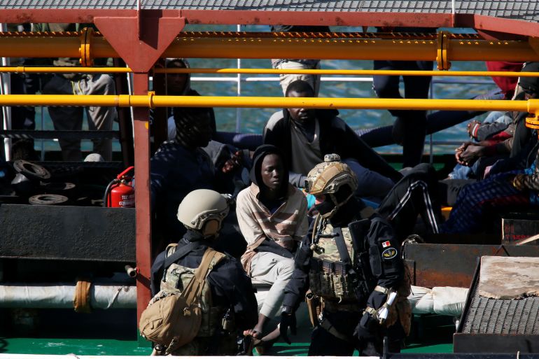 Maltese special forces soldiers guard a group of migrants on the merchant ship Elhiblu 1 after it arrived in Senglea, in Valletta's Grand Harbour, Malta, March 28, 2019. REUTERS/Darrin Zammit Lupi