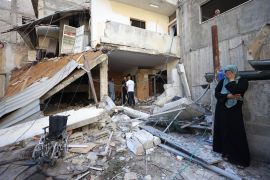 epa10879974 Residents look at a damaged home at the Nur Shams refugee camp near the West Bank city of Tulkarem