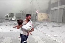 A medic runs as he carries an injured Palestinian child to ambulance in this screengrab taken from a video, in Gaza