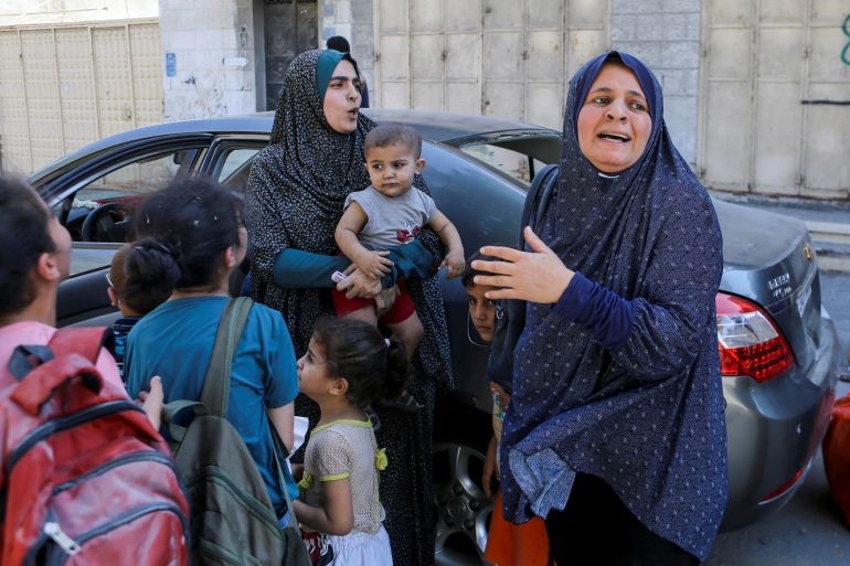 Palestinian women and children react following Israeli strikes in Gaza City