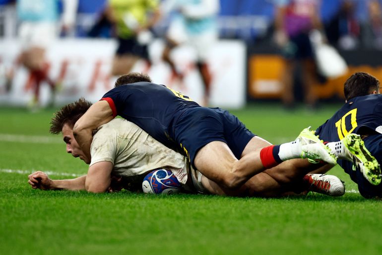 England's Theo Dan scores a try