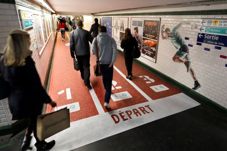 People walk in a metro station in Paris