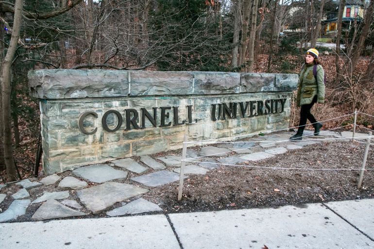 FILE - A woman walks by a Cornell University sign on the Ivy League school's campus in Ithaca, New York, on Jan. 14, 2022. The Cornell University student accused of making online threats against Jewish people on campus had mental health struggles and apparently showed remorse soon after, according to his mother, Monday, Nov. 6, 2023.(AP Photo/Ted Shaffrey, File)