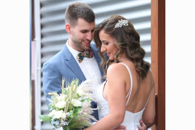 A photo of Yosep Genis on his wedding day standing next to his wife (right).