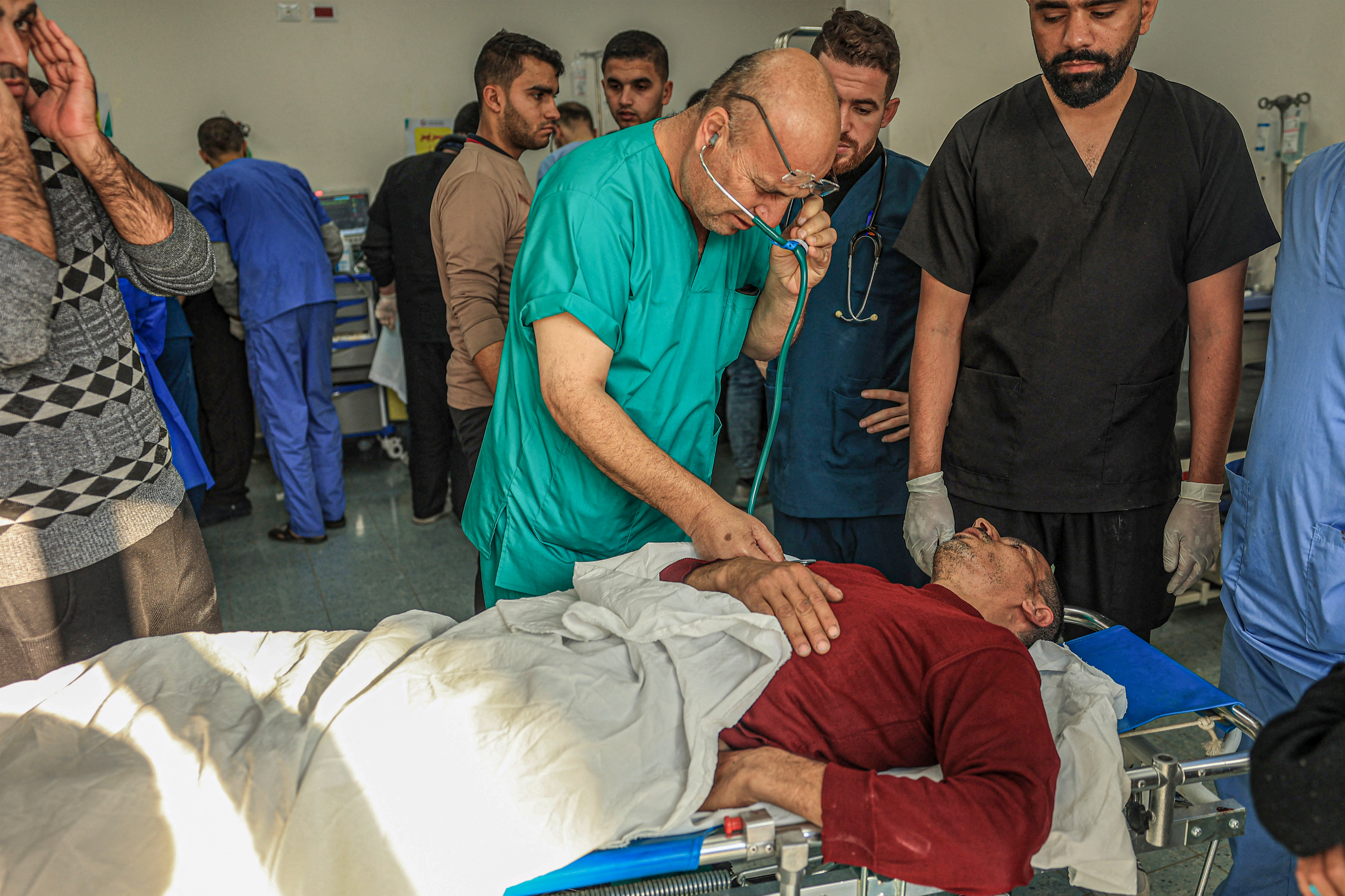 A medic tends to an injured man at the Kuwait hospital following Israeli bombardment in Rafah, in the southern Gaza Strip.