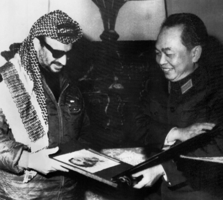 Yasser Arafat (L), commander of Al Fatah Palestinian movement, receives an album on the creation of the North-Vietnamese army with a picture of Ho Chi Minh on the cover from North-Vietnamese Defense Minister General Giap, during his visit in North-Vietnam 08 April 1970. AFP PHOTO (Photo by RADIOPHOTO / AFP)