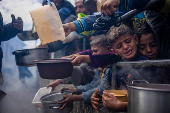 Palestinians line up for a meal in Rafah, Gaza Strip