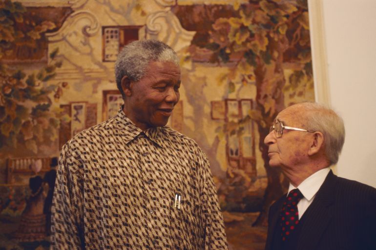 President Nelson Mandela talks with Percy Yutar, the prosecutor in the Rivonia treason trial in which Mandela was sentenced to life imprisonment. President of South Africa and longtime political prisoner, Nelson Mandela was held by the Candela based government from 1964-1990 for sabotage. With the coming of a freer political climate, Mandela was released from his life sentence at Victor Vester Prison on February 11, 1990. He went on to lead the African National Congress in negotiations with President F. W. de Klerk, that resulted in the end of apartheid and full citizenship for all South Africans. He and de Klerk received a joint Nobel Peace Prize in 1993 for their efforts. Mandela was elected President in 1994. (Photo by © Louise Gubb/CORBIS SABA/Corbis via Getty Images)