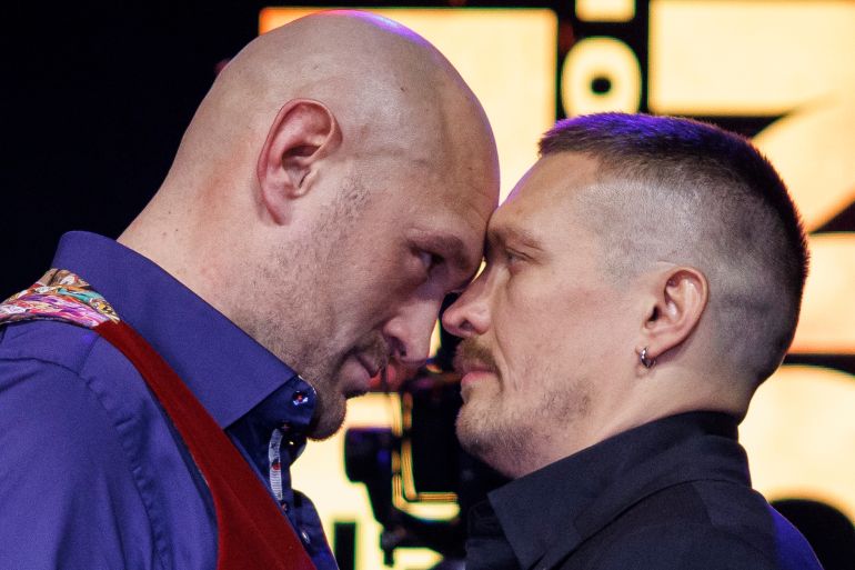 British boxer Tyson Fury (L) and Ukrainian boxer Oleksandr Usyk (R) face each other during a press conference ahead of Tyson Fury vs Oleksandr Usyk boxing match