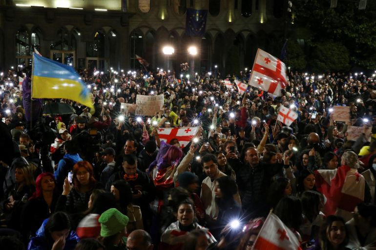 Demonstrators hold a rally to protest against a bill on "foreign agents", near Georgian Parliament building, in Tbilisi, Georgia, May 13, 2024