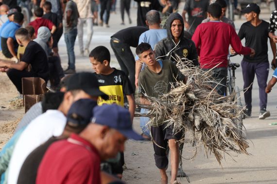 Palestinians gather in the hope of obtaining aid delivered into Gaza through a U.S.-built pier