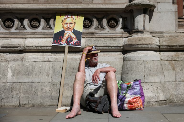 A supporter of Julian Assange sits outside of the Royal Court of Justice, on the day of an extradition hearing of the WikiLeaks founder