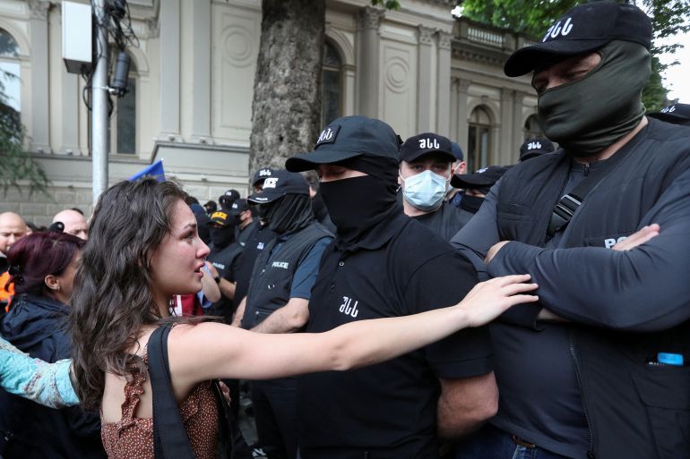 Demonstrators stand in front of law enforcement officers during a rally to protest against a bill on "foreign agents", after Georgia's parliament voted to override a presidential veto of the bill, in Tbilisi, Georgia, May 28, 2024. REUTERS/Irakli Gedenidze