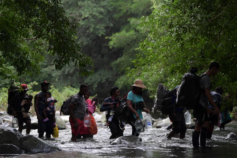 Haitian migrants cross the jungle of the Darien Gap, near Acandi, Choco department, Colombia, heading to Panama, on September 26, 2021, on their way trying to reach the US