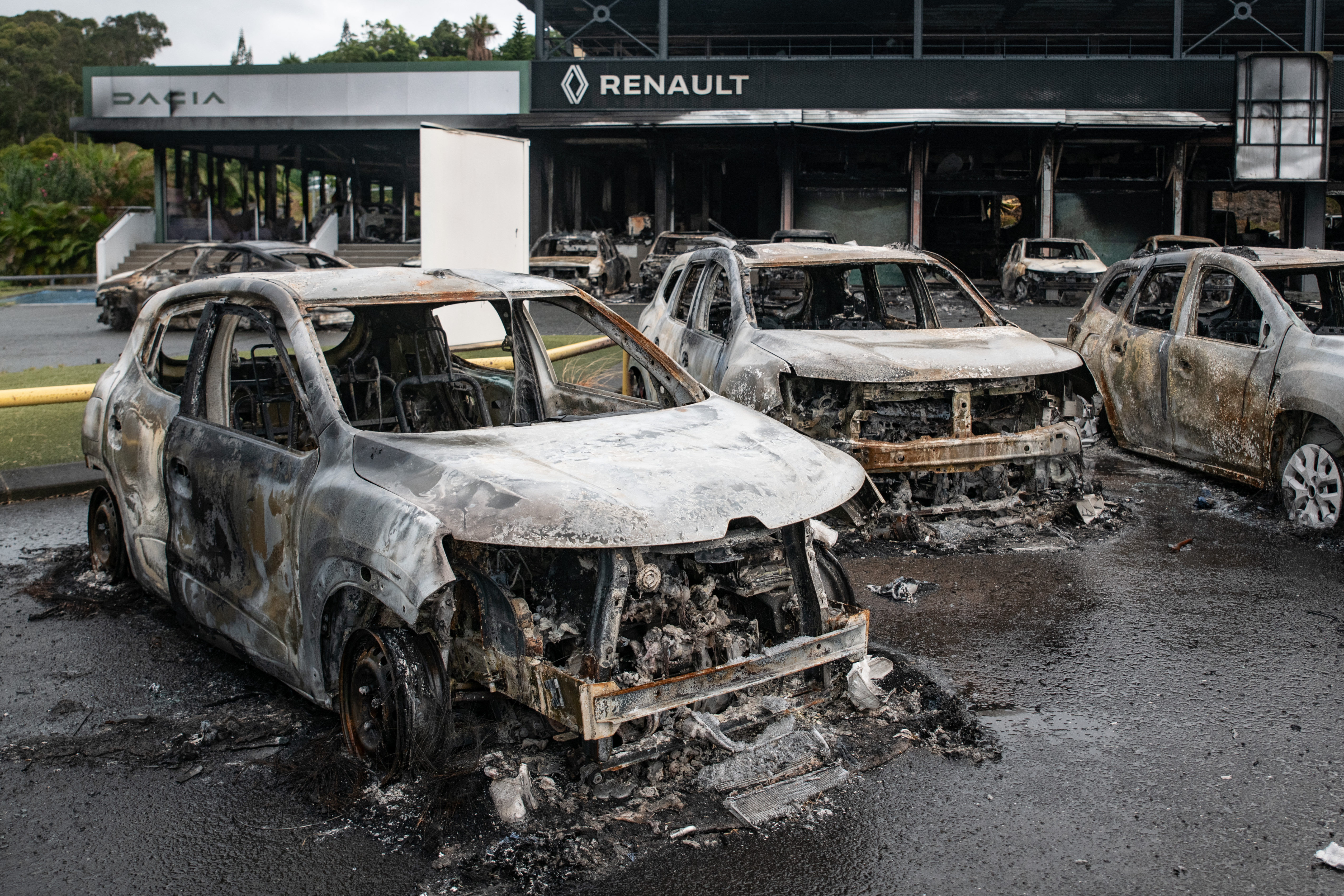 This photograph shows burnt cars of the Renault Dacia parking lot in the Magenta district of Noumea, France's Pacific territory of New Caledonia, on May 17