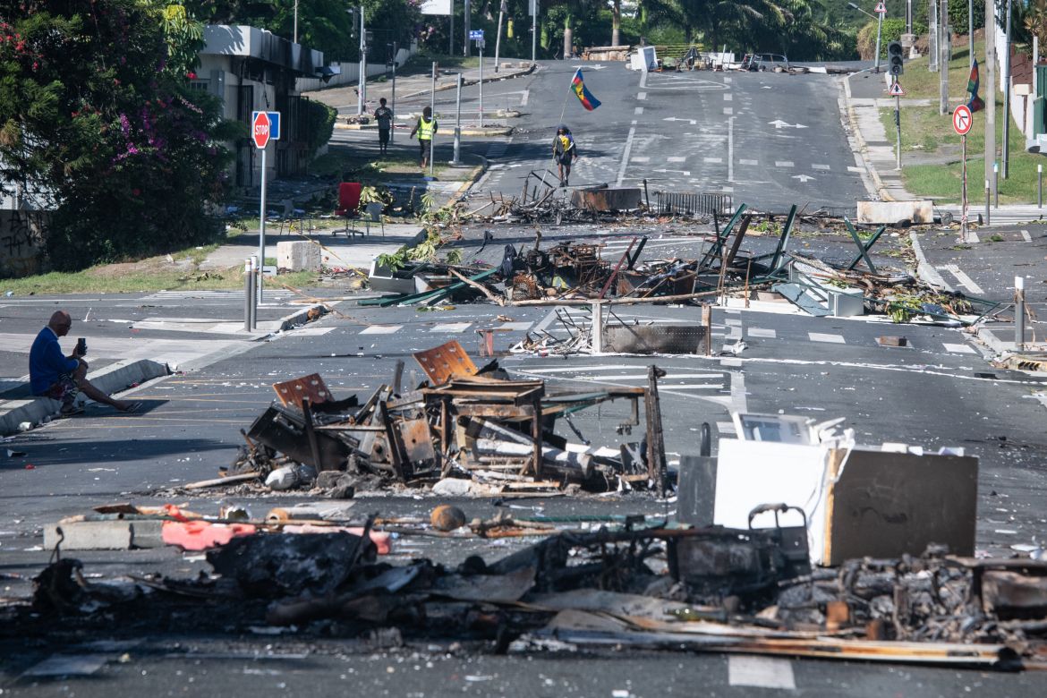 A street blocked by debris and burnt out items is seen following overnight unrest in the Magenta district of Noumea, France's Pacific territory of New Caledonia, on May 18