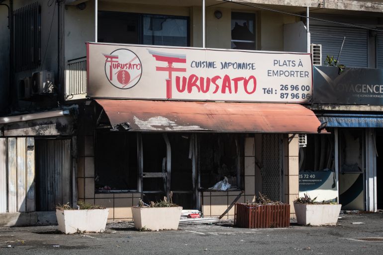 A torched restaurant is seen in the Magenta district of Noumea, France's Pacific territory of New Caledonia, on May 18