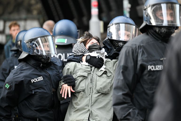 23 May 2024, Berlin: One of the pro-Palestinian occupiers of the Institute for Social Sciences at Berlin's Humboldt University (HU) is taken out of the building by two police officers. Activists have occupied the university in support of the Palestinians and in protest against Israel. Photo: Soeren Stache/dpa (Photo by Soeren Stache/picture alliance via Getty Images)