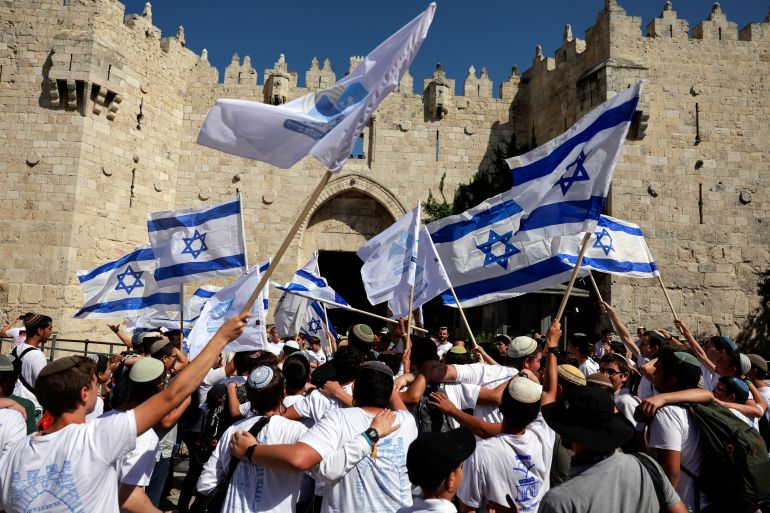 Israelis march through the alleyways of Jerusalem's Old City to the Western Wall, waving Israeli flags on 'Jerusalem Day' to commemorate the establishment of Israeli control over the city.