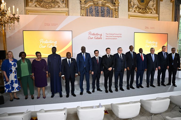 Macron and EU leaders in dark suits on a stage