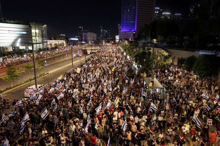 People attend a demonstration against Israeli Prime Minister Benjamin Netanyahu's government and a call for the release of hostages in Gaza