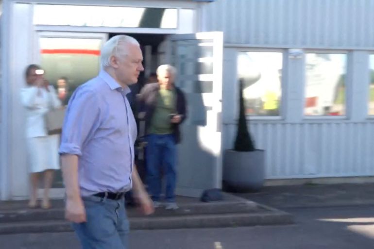 WikiLeaks founder Julian Assange walks to board a plane at a location given as London, Britain, in this still image from video released JUNE 25, 2024.