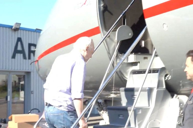 WikiLeaks founder Julian Assange boards a plane at a location given as London, UK