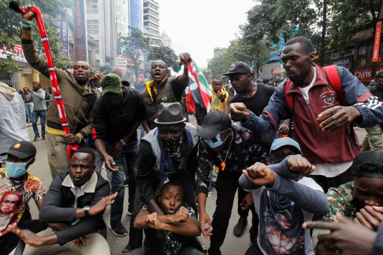 People gesture as they take part in a demonstration over police killings of people protesting against Kenya's proposed finance bill