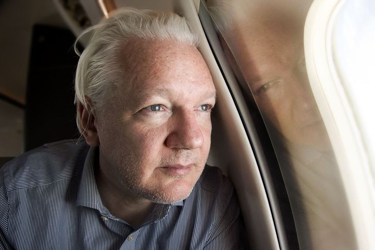 This handout courtesy of the WikiLeaks X account @wikileaks posted on June 25, 2024 shows WikiLeaks founder Julian Assange looking out of the window as his plane from London approaches Bangkok for a layover at Don Mueang International Airport in the Thai capital.