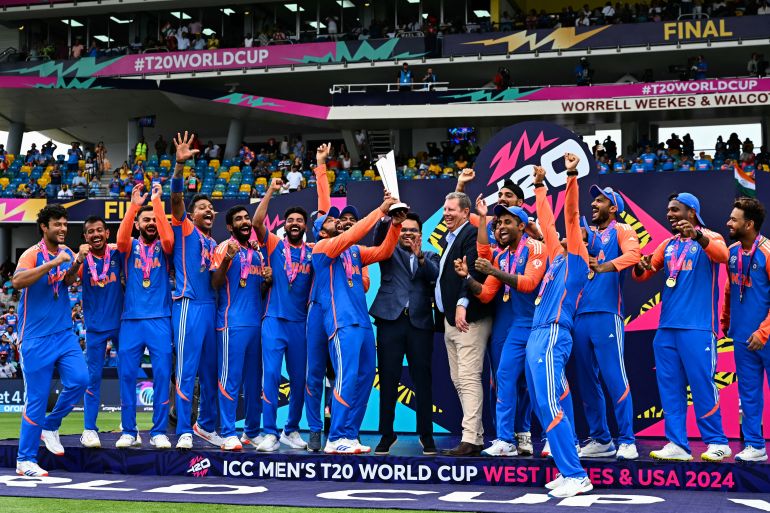 Team India celebrates with the trophy after winning the ICC men's Twenty20 World Cup 2024 final cricket match between India and South Africa at Kensington Oval in Bridgetown, Barbados, on June 29, 2024. (Photo by CHANDAN KHANNA / AFP)