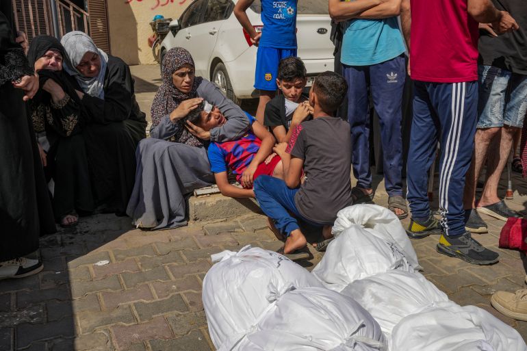 Palestinians mourn their relatives killed in the Israeli bombardment of the Gaza Strip