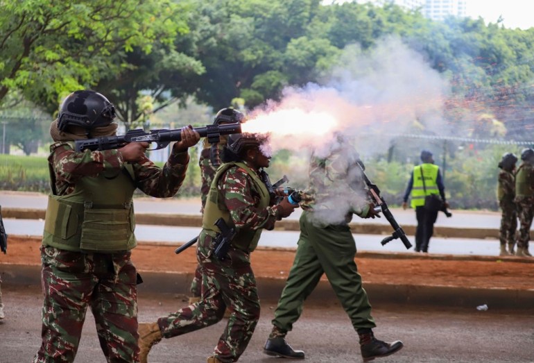 Police officers fire tear gas canisters during a protest over proposed tax hikes in Nairobi, Kenya