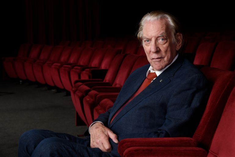 Donald Sutherland. He is seated in a chair and looks at ease.