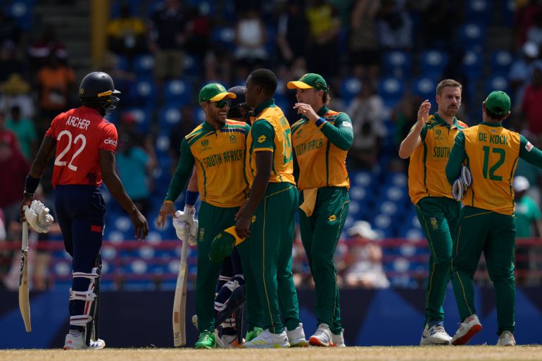 South Africa players celebrate after their win in the ICC Men's T20 World Cup cricket match between England and South Africa at Darren Sammy National Cricket Stadium in Gros Islet, Saint Lucia, Friday, June 21, 2024. (AP Photo/Ramon Espinosa)