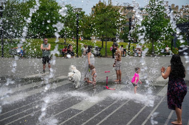 People cool down in a fountain in Washington DC