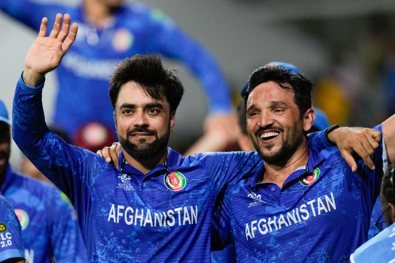 Afghanistan's captain Rashid Khan, left, and teammate Gulbadin Naib celebrate after defeating Bangladesh by eight runs in their men's T20 World Cup cricket match at Arnos Vale Ground, Kingstown, Saint Vincent and the Grenadines, Monday, June 24, 2024. (AP Photo/Ricardo Mazalan)