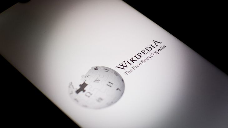 The Wikipedia logo is being displayed on a smartphone screen in Athens, Greece