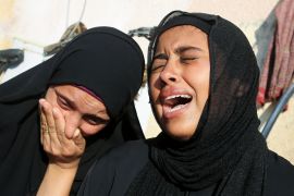 Relatives of a Palestinian killed in an Israeli attack on a school sheltering displaced people in Khan Younis, southern Gaza. [Hatem Khaled/Reuters]