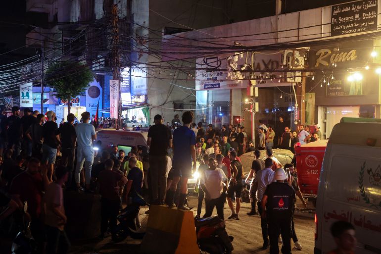 People gather where an Israeli air strike targeted the southern parts of Beirut.