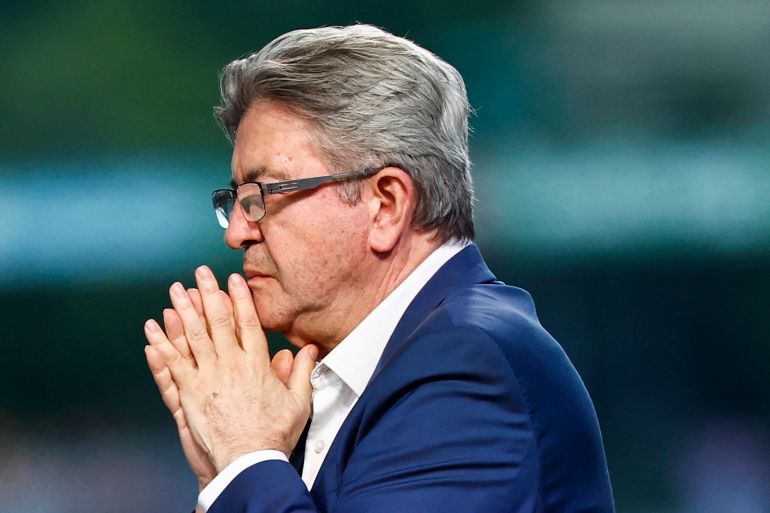 Founder of left-wing party La France Insoumise (LFI) Jean-Luc Melenchon reacts during the election night of left-wing party La France Insoumise (LFI) following the first results of the second round of France's legislative election at La Rotonde Stalingrad in Paris on July 7, 2024. - A broad left-wing coalition was leading a tight French legislative election, ahead of both President's centrists and the far right with no group winning an absolute majority, projections showed. (Photo by Sameer Al-Doumy / AFP)