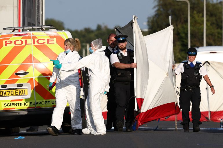 Police officers and forensic personnel put up a fence on Hart Street in Southport, northwest England, on July 29, 2024, following a knife attack.