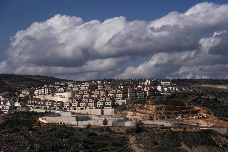 rows of neat houses surrounded by a large concrete wall