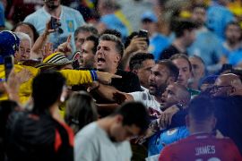 Uruguay&#039;s players argue with fans at the end of a Copa America semifinal against Colombia in Charlotte, North Carolina, the United States [Julia Nikhinson/AP]