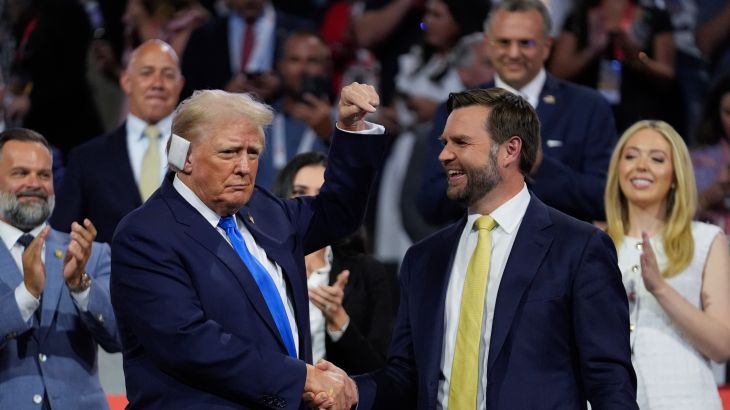 Donald Trump, with a bandage on his ear, shakes hands with JD Vance at the 2024 Republican Convention.