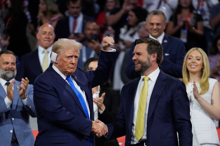 Donald Trump, with a bandage on his ear, shakes hands with JD Vance at the 2024 Republican Convention.