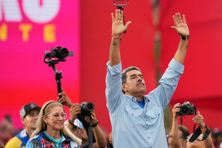 President Nicolas Maduro raises his arms in the air, his eyes closed, at a final campaign rally in Caracas.